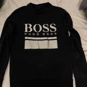 Svart Boss tröja - Svart boss tröja med silver loga. Passar både Xs-S. Tröjan är i bra skick 