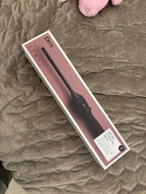 Cera Micro Curling Iron - Cera Micro Curling Iron i originalförpackning, ser ut att vara i nyskick utan synligt slitage. Perfekt för att skapa små, definierade lockar. Levereras med lång sladd och instruktionshäfte. Stilren design och enkel att använda. Aldrig använd.