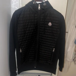 Svart quiltad pufferjacka - Svart pufferjacka från i storlek XL men sitter som en M/L. Jackan har quiltad framsida och rygg. Med luva