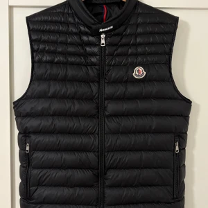 Moncler väst  - Svart moncler väst                                            storlek 3/4=M,L                                                                 Nyskick, använd ett fåtal gånger.                                    Nypris (7000kr). Mitt pris (2000kr) vid snabb och smidig affär kan vi diskutera om priset!                     Dm för minsta lilla fråga!😃