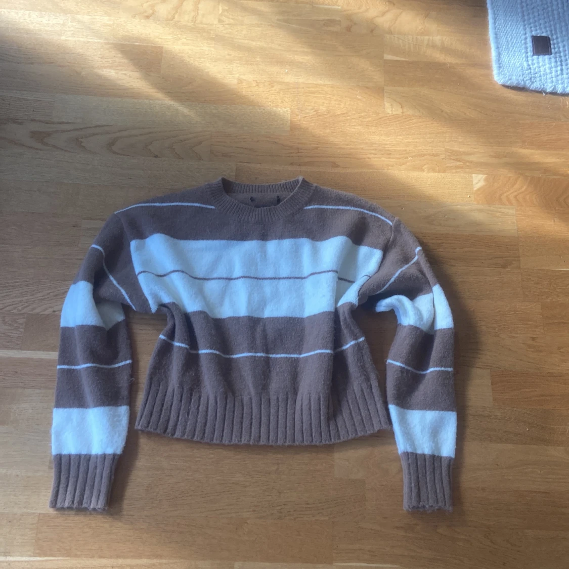 Randig brun och vit stickad tröja