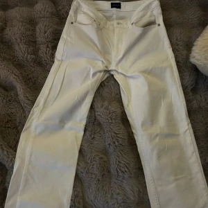 Vita raka jeans från Gant - Snygga vita jeans från Gant med klassisk femficksdesign och raka ben. Byxorna har en normal passform och är tillverkade i mjukt bomullsmaterial. Perfekt för dig som gillar stilrena och fräscha jeans med diskret Gant-logga på bakfickan. Köpta för 1300kr