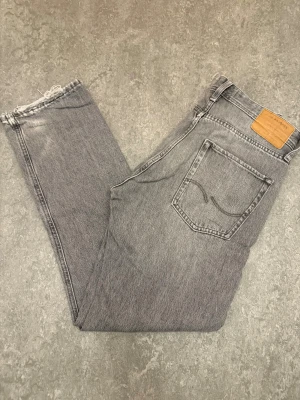 Jack & Jones Jeans - Tja! Säljer dessa stilrena gråa Jack & Jones jeansen ! Storlek W29 / Skick 8/10! Passform - Relaxed / Priset är ej hugget i sten,  tveka inte att kontakta vid frågor eller funderingar!