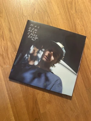 Salad Days - Vinylalbumet 'Salad Days' av Mac DeMarco är perfekt för dig som älskar indie och chill musik. Omslaget har en avslappnad vibe med bilder från artistens vardag och studio. Ett måste för unga musikälskare som vill ha något unikt i sin samling! Tyvärr har den fått en liten buckla pga solljus. Den är dock aldrig spelad. 