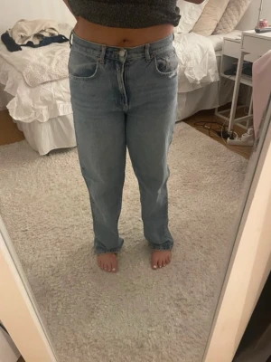 Ljusblå raka jeans från Levi's - Säljer ett par ljusblå raka jeans från Gina tricot med klassisk femficksdesign och hög/medelhög midja. Jeansen har en avslappnad passform och är tillverkade i slitstarkt denimtyg. 