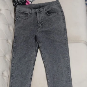 Grå jeans från Gentle Man Jeans, strl 32 - Snygga grå jeans från Gentle Man Jeans i klassisk femficksmodell. Jeansen har en rak passform med normal midja och är tillverkade i ett slitstarkt denimtyg. Perfekta för dig som gillar en stilren och enkel look.