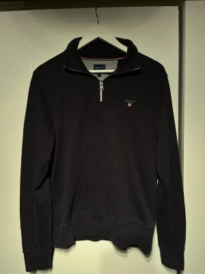 Gant quarter Zip mörkblå - Mörkblå gant zip, i storlek M. Den är i använt skick men fortfarnade riktigt stilig. Modellrn är 177cm och passar den fint🤩