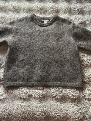 Kortärmad stickad tröja - Mysig brungrå stickad tröja från Gina Tricot i storlek 146/152. Tröjan är i bra skick och jag säljer den för att den är för liten❤️