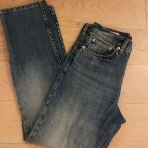 Blå raka jeans från Zara, strl 36 - Säljer ett par klassiska blå jeans från Zara i storlek 36. Jeansen har rak passform, fem fickor och hög midja. Materialet är slitstarkt bomullsjeans med snygg tvättad look. 