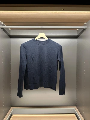 Mörkblå stickad tröja Samsøe Samsøe - Snygg mörkblå stickad tröja från Samsøe Samsøe. Klassisk rund halsringning och långa ärmar. Perfekt till lager på lager och funkar året runt. Enkel och stilren design som passar till allt.