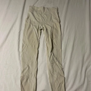 Beige leggings från Flink - Säljer ett par beige leggings från Flink med bred ribbad midja för extra komfort. De är stretchiga och har en tight passform som sitter snyggt på kroppen. Perfekta för träning eller chill dagar. Materialet är mjukt och följsamt. Passar nog de flesta storlekar!