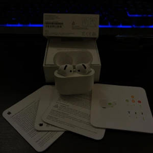 AirPods 4 - Apple AirPods Pro med originalförpackning och tillbehör. Trådlösa hörlurar med aktiv brusreducering och laddningsetui. Mycket fint skick, inga synliga repor eller skador. Perfekt för musik, samtal och träning.