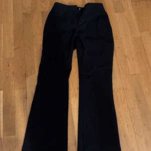 Svarta bootcut kostymbyxor från Zara XS - Svarta kostymbyxor från Zara i storlek XS.  Dom är helt oandvända har bara testat dom.Byxorna har bootcut-modell med utsvängda ben och hög midja. Snygg minimalistisk look med dolda bakfickor och diskret dragkedja framtill. Perfekta för en clean och stilren outfit. 