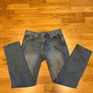 Levi's 502 blå jeans  - Klassiska blåa Levis 502, snygga kontrastsömmar och ikonisk läderpatch bak i midjan. Tillverkade i slitstarkt denimtyg av bomull. Perfekta för en avslappnad och tidlös look. Tapered fit, alltså en blandning mellan slim fit och regular fit, sitter alltså perfekt. 