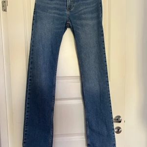 Blå raka jeans från Nelly - Snygga blå jeans från Nelly med klassisk femficksdesign och raka ben. Modellen ”low waist straight leg jeans” i färgen blue. 