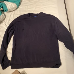Mörkblå/navy färgad sweatshirt från Jack & Jones - En stilren navyfärgad  sweatshirt från Jack & Jones Originals. Tröjan har rund halsringning, långa ärmar och är tillverkad i mjuk bomullsmix. Perfekt för en chill och enkel look.