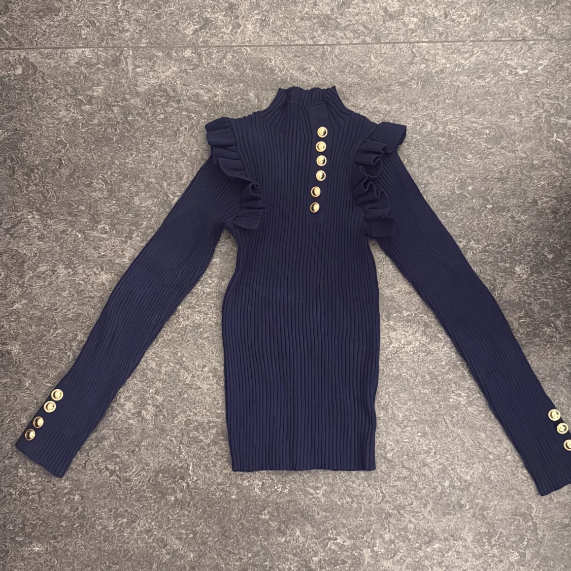 Mörkblå ribbad tröja med volang