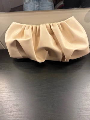 Beige kuvertväska från LXA - Säljer en beige kuvertväska från märket LXA. Knappt använd så skicket på väskan är i princip som nytt.