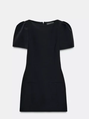 Zara klänning - Snygg svart kort klänning med puffiga korta ärmar och rund hals. Klänningen har en stilren och enkel design med figurnära passform och diskreta sömmar framtill. Perfekt för dig som gillar minimalistisk stil och vill ha en klassisk look.