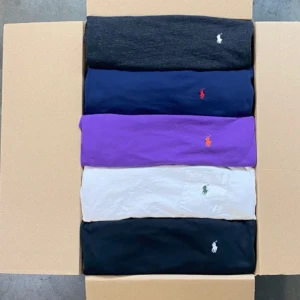 Flerpack Polo Ralph Lauren t-shirts - Säljer ett paket med fem klassiska t-shirts från Polo Ralph Lauren i olika färger: svart, marinblå, lila och vit. Alla har broderad logga på bröstet, en av de vita har bröstficka. T-shirtsen är i mjuk bomull och har normal passform med kort ärm. Säljer dom i tyck för 250 elelr alla för 1000