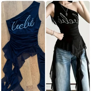 Svart oneshoulder topp från Leebé S - Säljer en svart oneshoulder topp från Leebé med glittrigt strass-tryck framtill. Toppen har asymmetrisk design, transparenta volanger i mesh och en tight passform. Perfekt för dig som vill sticka ut med cool stil och snygga detaljer.