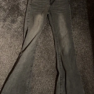 Grå bootcut jeans med utsvängda ben - Snygga grå jeans med bootcut-modell och utsvängda ben. Jeansen har en klassisk femficksdesign och är tillverkade i ett mjukt denimtyg. Använda 1 gång men ser ut som nya 
