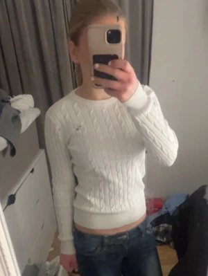 Vit kabelstickad tröja från Gant - Vit kabelstickad tröja från Gant med rund halsringning och diskret logga broderad på bröstet.  Perfekt för en stilren och klassisk look. Storlek xs. Köpte för 1500 o säljer för 750 men priset kan diskuteras 