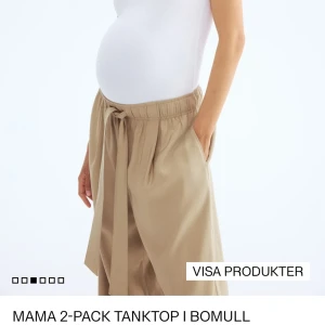 2-pack mamma linnen i bomull, svart/vit - Säljer ett 2-pack mamma-linnen från H&M i storlek L. Ena linnet är vitt och det andra är svart, båda i mjuk bomull med klassisk rund halsringning och ärmlös design. Perfekta för dig som vill ha bekväma och stilrena basplagg under graviditeten.