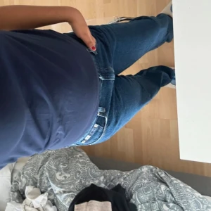 Blå jeans från Calvin Klein - Säljer ett par klassiska blå jeans från Calvin Klein med rak passform och normal midja. Jeansen är tillverkade i 100% bomull och har en snygg CK-logga på bakfickan. Perfekta för dig som gillar en tidlös och clean look.