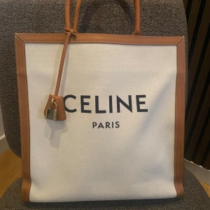 CÉLINE Cabas Vertical Tote - Selling a Céline Cabas Vertical Tote, Very slightly used. Good overall condition, no wear, only used a few times. Please more the stain on the inside, Coca-Cola bottle has leaked into the bag. 