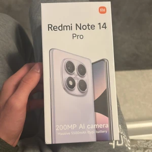 Redmi Note 14 Pro - Ny Redmi Note 14 Pro med 8GB RAM och 256GB lagring. Utrustad med en kraftfull 200MP AI-kamera och ett massivt 5500mAh batteri. Färgen är Midnight Black. Förpackningen är obruten och i ny skick, redo att användas direkt. Laddare finns med i kartongen. 