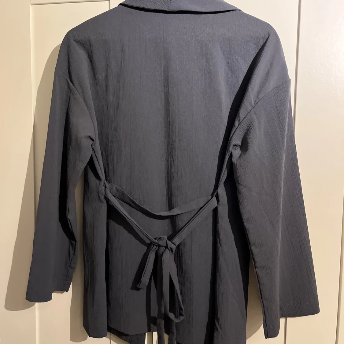 Mörkgrå omlott kavaj med knytband