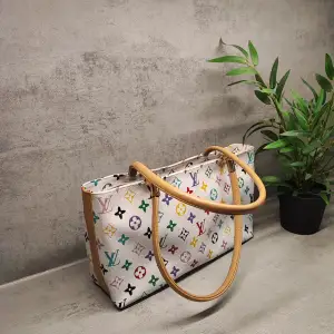 Söt liten vintage handväska. Louis vuitton multicolor. Ej äkta. Kan skickas, men då tillkommer porto. Två små fläckar på baksidan. Kan skicka fler bilder