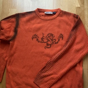 Stickad tröja med tryck - Asfet stickad tröja med svart print! Köpt på humana och passar asbra med lightwash jeans. Den är ganska lång men om man vill kan man ju sy upp den lite :)