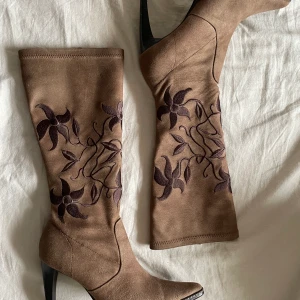 Mocka stövlar!! - Otroligt snygga mockastövlar med blom mönster på, snygga och ovanliga. Bekväma stt gå i och är i bra skick. Strl 37 men passar även 36 som jag har.