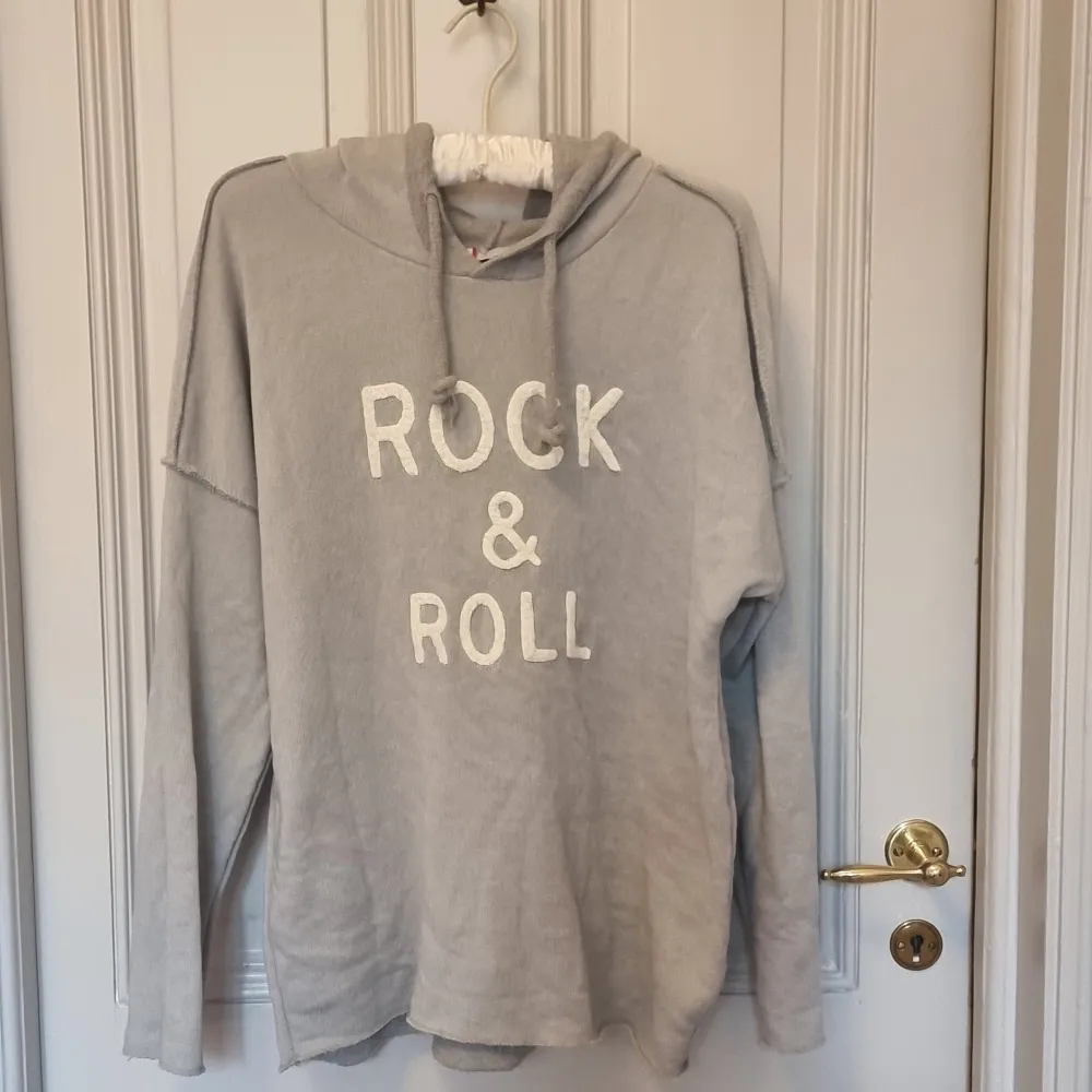 Rock and Roll tröja med tryck. Grå hoodie som är alldrig andvänd. Välldigt Zadig och Voltair aktigt. Köpt i år från ett franskt/italienskt märke. Snygg i passformen. Säljer då den är för litten. Hoodies.