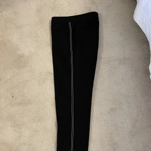 Kostymbyxa Twist & Tango strlk 36 - Marinblå kostymbyxa med vitblå stripes på sidan i oanvänt skick pga för små