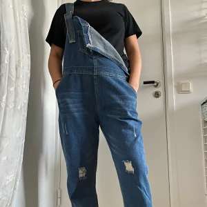 Vintage hängselbyxor  - Ett par hängselbyxor köpta på en vintagebutik i Berlin. Snygg modell och fin tvätt. Går att anpassa längden i benen samt i hängslena. Stl L men passar allt från S