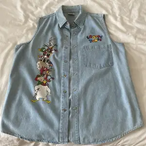 Denim Vest with Looney Tunes characters on it. Nice buttons that snap on and never been used. Perfect condition.