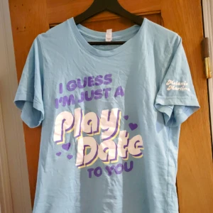 Melanie Martinez  - Melanie Martinez play date t-shirt slutsåld. Sparsamt använd och i gott skick. Är storlek S men passar M. Säljer eftersom den inte kommer till användning. Be om fler bilder om du vill. Frakt utifrån postens priser. Köpt för 535kr (frakt inräknat). 
