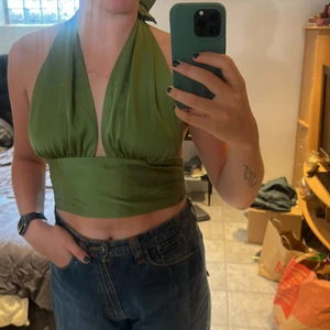 Grön halternecktopp - Mycket fint skick, säljer då den är lite stor i bysten.😊 Ostechigt material. Använd en gång