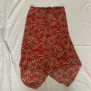 Blommig kjol  - Röd kjol med blommor och knytning i midjan 