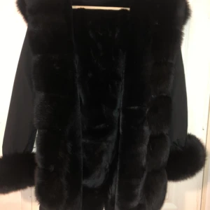 Garoff parka svart pälsjacka  - En svart parka storlek M. Den är i fint och nyskick och är oanvänd. Varm och mjuk äkta päls, man kan även ta av pälsen på luvan, armarna och framsidan. Jackan är köpt från Garoff. Nypris idag i affären är ca. 4000 kr. Kan diskutera priset❤️