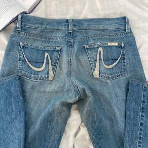 Ett par asballa lågmidjade jeans, som tyvärr inte kommer till användning 💕Speciella, coola fickor och jeansen är knappast använda. 🤗 Står 38 i storleken men skulle säga att de anpassar sig mycket. ❤️ - Midjemått rakt över: 38 cm. - Innerbenslängd: 72 cm. 