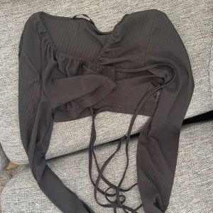 Crop top med snörning  - Crop top med snörning man kan justera. Passar mindre bröst. XS-M. 