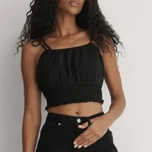 Svart linne från nakd - ”Rynkad topp” från Nakd i storlek 34. Linne med Band man knyter själv. Nyskick. Köpt för 219, säljs för 40.🤩