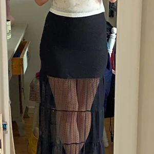 Lång kjol - Svart lång volangkjol. Underkjolen sitter ihop med själva kjolen. Använd endast ett fåtal gånger. 