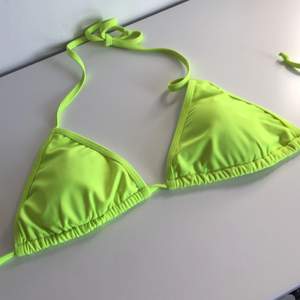 En neon grön/gul bikini överdel som är för liten för mig i kupan. Jätte fin o går att trixa o fixa med 