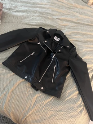 Oanvänd skinn jacka  - Helt oanvänd skinnjacka säljes, pågrund av att ja inte gillade skinnjacka och råka dra bort prislappen.  Storlek L men skulle säga att den passar M också om man har en hoddie under.   Skickar med spårbart. Jag ansvarar inte för postens slarv. 