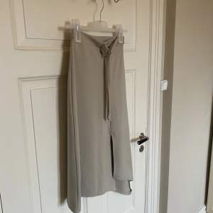 Säljer denna snygga kjolen från Boohoo. I fint skick. Storlek 36. Slits på sidan. Färgen är beige. Längre modell. 